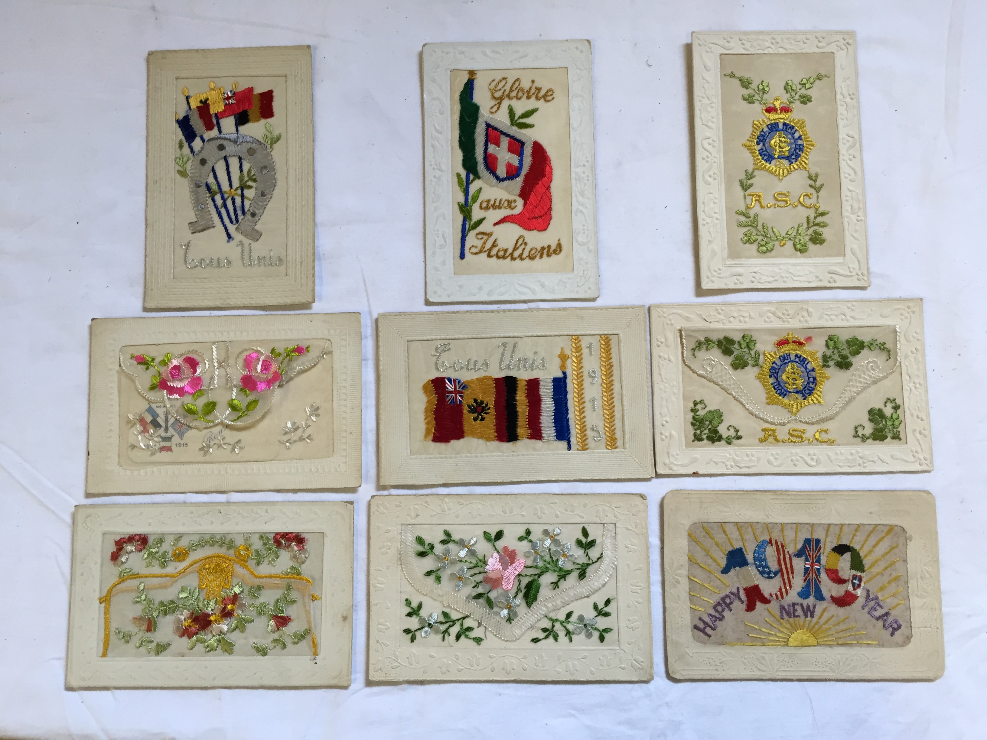 A selection of nine World War I silk postcards embroidered