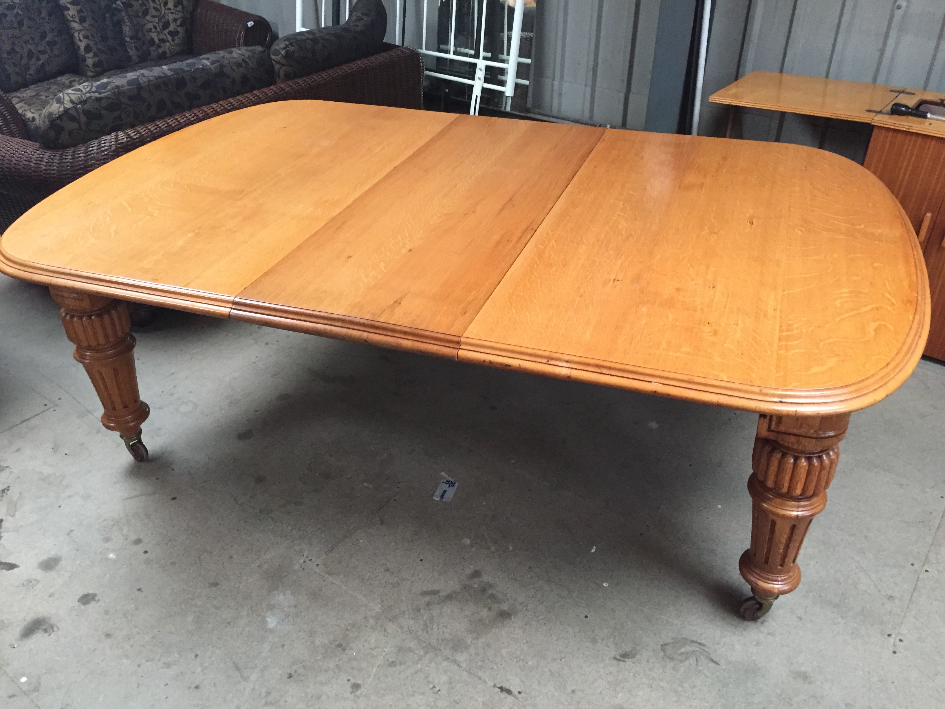 * A large Victorian light oak extending table with winding mechanism. - Image 2 of 4