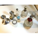 Two silver candlesticks and and other silver toped pieces.