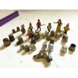 A selection of thimbles and Snow & The Seven Dwarfs figures and a silver dogs head.