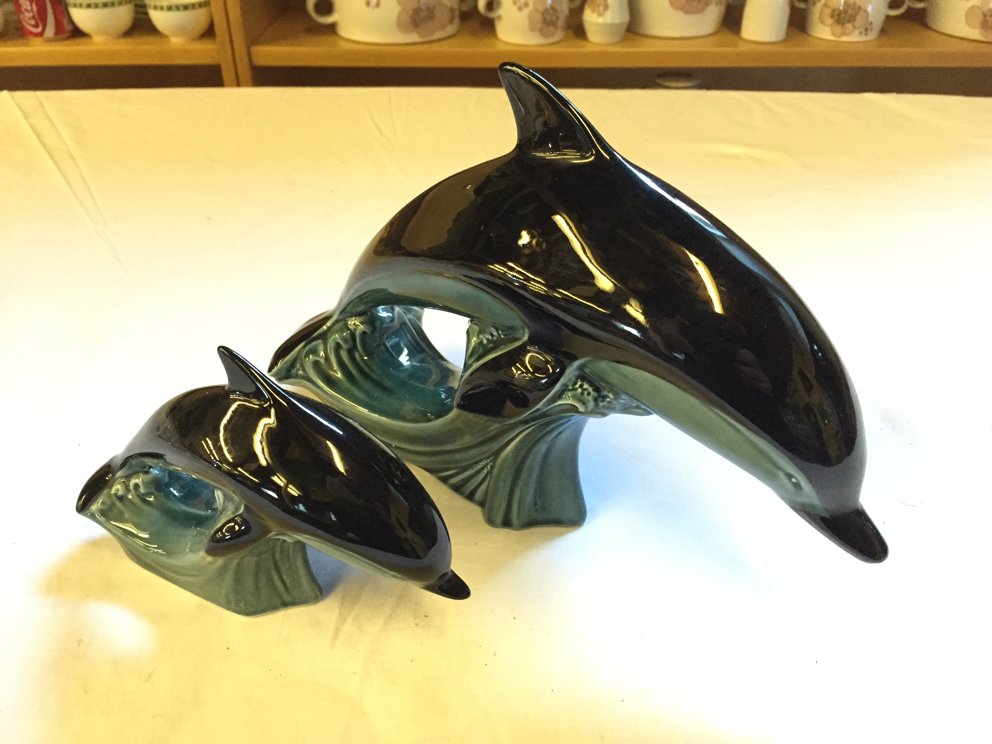 Two Poole Pottery Dolphins 180 mm and 110 mm high.