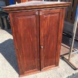 An early Victorian mahogany wall hung corner cabinet.