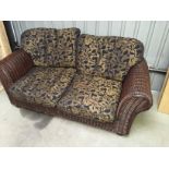 *A two seater cane sofa.