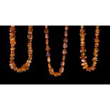 Konvolut Bernsteinketten/ Bundle of Amber Necklaces  3 Stück, honigfarben, L: 80 cm, 52 cm , 50
