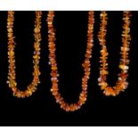 Konvolut Bernsteinketten/ Bundle of Amber Necklaces  3 Stück, honigfarben, L: 68 cm, 64 cm , 58