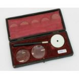 Optisches Gerätaus dem Nachlaß eines Augenarztes, um 1910, 7 Linsen mit verspiegeltem Halter, im