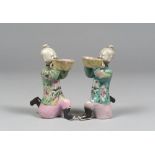 PAIR OF SCULPTURES IN POLYCHROME GLAZE PORCELAIN, CHINA 19th CENTURY depicting two children in