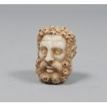 SMALL HEAD IN ALABASTER, 17TH CENTURY depicting a man. Measures 7 by 6 by 6 cm.