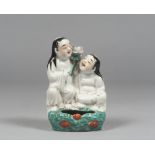 GROUP IN POLYCHROMEPORCELAIN , CHINA 19TH CENTURY depicting He He Er Xian supporting lotus