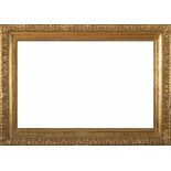 WOOD AND STUCCO FRAME, 20TH CETNURY entirely gilded, with motif of leaves and pomegranites. Inner