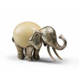 COMPOSITION WITH OSTRICH EGG AND GOLDEN METAL, 20TH CENTURY depicting an elephant. Measures cm. 20 x