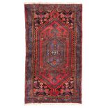 HAMADAN RUG, EARLY 20TH CENTURY double medallioin, palmette and herati motif in field on red base.
