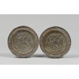 PAIR OF SMALL BRASS ALMS DISHES, 17TH CENTURY embossed with lion figures. Diameter 25 cm. Defects.