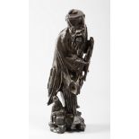 SCULPTURE IN BLACK LAQUERED WOOD, CHINA EARLY 20TH CENTURY depicting a fisherman holding a fish