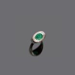 RING in white gold 18 kt., with central oval cut emerald and diamond surround. Diamonds ct. 0.15,