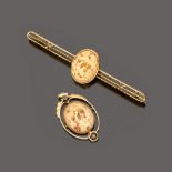 SET OF BROOCH AND PENDANT in yellow gold 18 kt., central ivory. Length brooch cm. 9,5, length