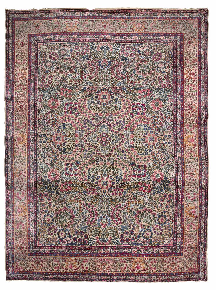 KIRMAN RUG, EARLY 20TH CENTURY rich design with blossom, in centre field with blue base. Border with