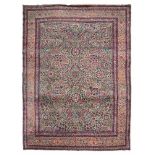 KIRMAN RUG, EARLY 20TH CENTURY rich design with blossom, in centre field with blue base. Border with
