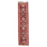 SAMARKANDA RUNNER RUG, SECOND HALF 20TH CENTURY sequence of medallions with herati on red base.