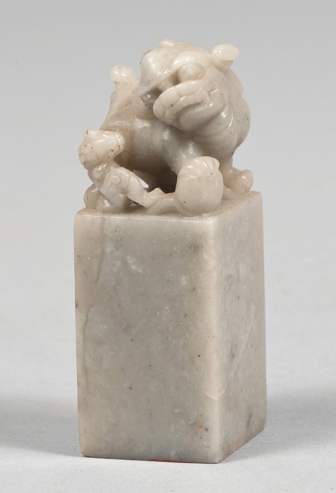 SEAL IN SOAPSTONE, CHINA 20TH CENTURY parallelepiped body and mythological lion hand piece.