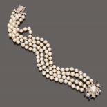 FINE BRACELET four strings of white cultivated pearls, clasp in white gold in flower shape with