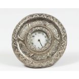 SMALL TABLE CLOCK, 20TH CENTURY entirely coated in embossed silver. Face signed 'Veglia'. Size cm.