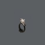 FINE RING in white gold 18 kt., star shaped studded with white and black diamonds. Diamonds ct. 0.