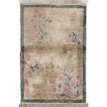 CHINESE BEDSIDE RUG, 20TH CENTURY empty field, floral motif on beige base. Border in green. Size cm.