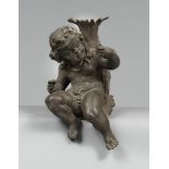 FIGURE OF PUTTO IN IRON, 19TH CENTURY

Size cm. 33 x 20 x 22.

Defects and missing parts.
