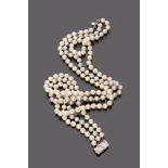 FINE NECKLACE

three strings of white and grey saltwater pearls, clasp in white gold 18 kt. and