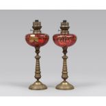 PAIR OF LAMPS IN GILT METAL, 19TH CENTURY

oil lamps, with pink glass vials decorated in gold.