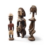 TRE AFRICAN SCULPTURES, 20TH CENTURY
in wood. Two figures are female and nude,while the male is