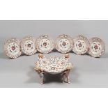 CAKESTAND AND SIX PLATES IN PORCELAIN, 20TH CENTURY
polychrome glazing. Support with figures of