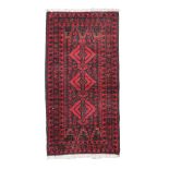 SMALL BELUCISTAN RUG, EARLY 20TH CENTURY
rhomboid medallions, on black and red base.
Size cm. 95 x