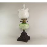 OIL LAMP.
A cast iron oil lamp, with glass fount. Max. height 58cm. CONDITION REPORTS: The fount