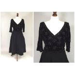 COCKTAIL DRESS. 
A lady's 1950's cocktail dress with black beaded bodice. CONDITION REPORTS: There
