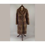 FUR COAT.
A 1940's/50's fur coat with shawl collar. Length 101cm. CONDITION REPORTS: The coat is