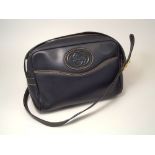 GUCCI HANDBAG.
A 1980's navy blue leather Gucci shoulder bag, with blue suede lining.
18 x 25cm.