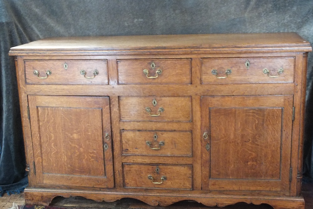 Desirable C18th honey coloured oak sideboard.  Two large drawers either side of three further