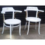 Two white painted bentwood chairs with arms and round seats, gold decoration