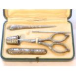 Five piece Art Nouveau sewing set in green leather case