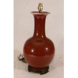 Large Oriental Sang de Boeuf / Oxblood ceramic baluster shape vase, sleeve neck, converted to