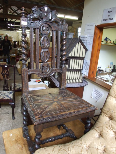 A NORTH COUNTRY CARVED HALL OAK CHAIR WITH BARLEY TWIST LEGS AND STRETCHER