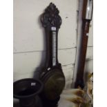 A 'BANJO' BAROMETER IN OAK WITH BRASS FACE - CARVED