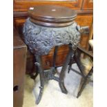 A HIGHLY CARVED CHINESE URN STAND WITH FLOWER AND FERNS