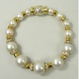An 18ct gold, cultured pearl and diamond