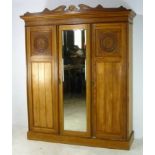 A large Edwardian wardrobe having fitted