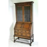 A fall front oak bookcase bureau in the