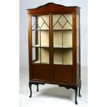 An Edwardian mahogany glazed cabinet wit