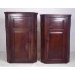 A pair of George III oak corner cupboard